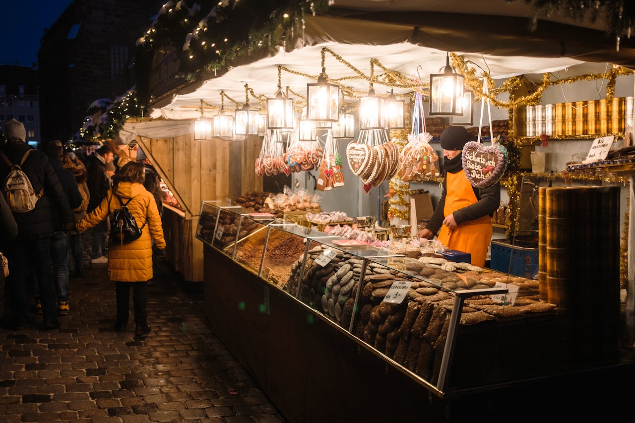 Festive evening at Nuremberg Christmas market with illuminated stalls and traditional gingerbread.