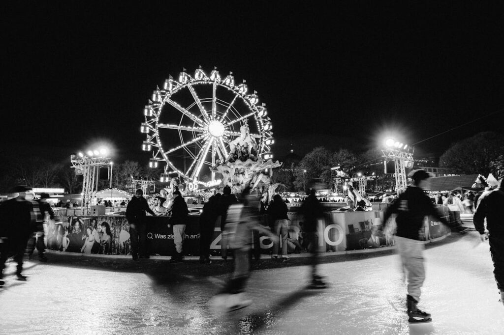 pexels photo 29732299 Nighttime ice skating at a winter festival with a Ferris wheel in Berlin.