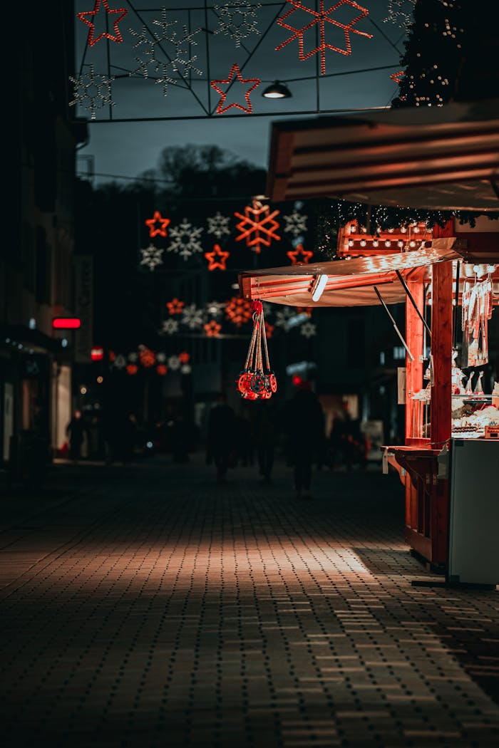 portfolio-03 A vibrant night scene at a festive market street with glowing Christmas lights and decorations.